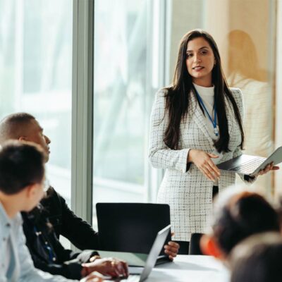 Female business owner confidently presents during a board meeting