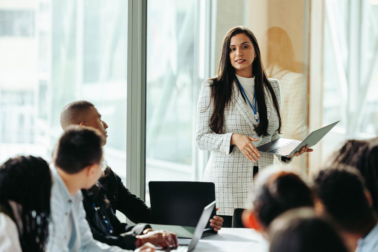 Female business owner confidently presents during a board meeting